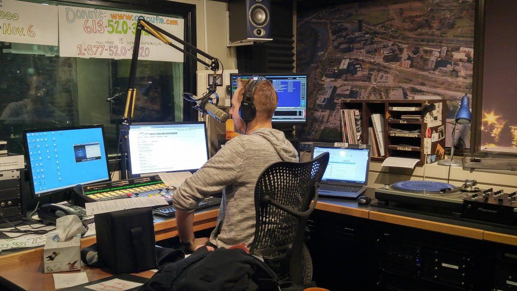 Ryan Bresee sits in the on air studio at CKCU.